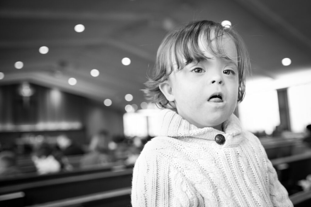 toddler boy in the pews at church