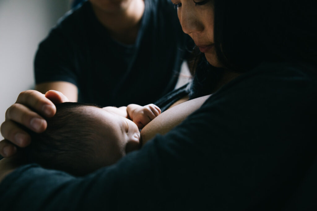 newborn baby is being fed in the nursery during a family photo session in san francisco.