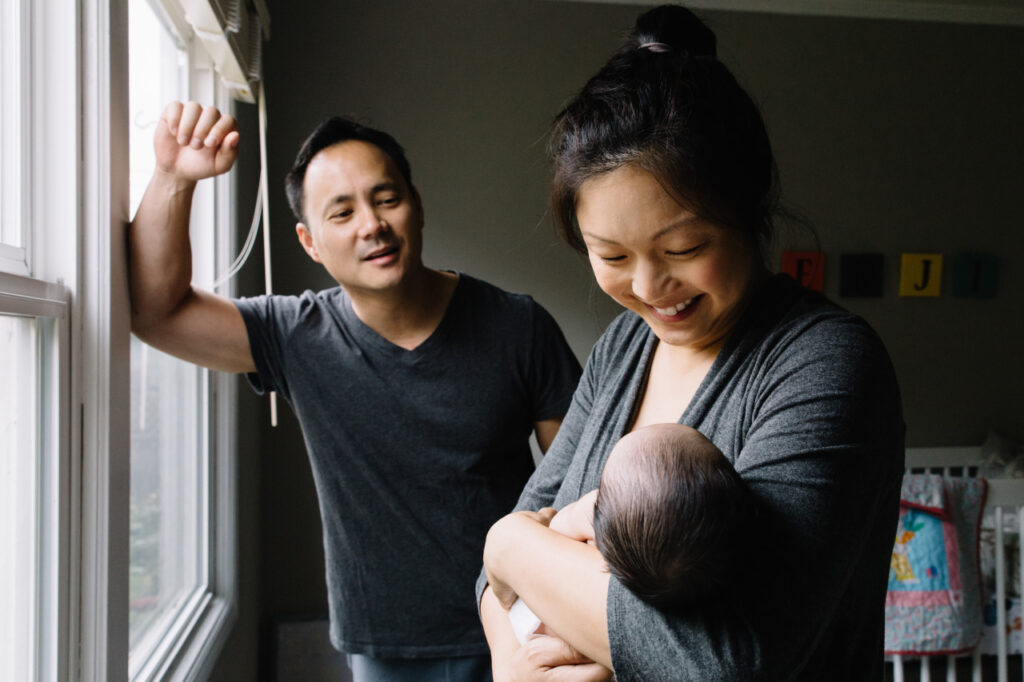 new parents smiling at their son during a newborn session in san franciso.