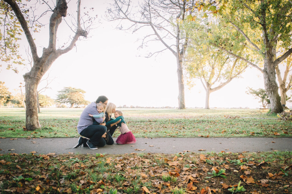 Family hugging on a paved path at Alameda Crown Beach.