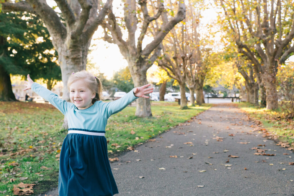 Young toddler girl running at alameda crown beach.