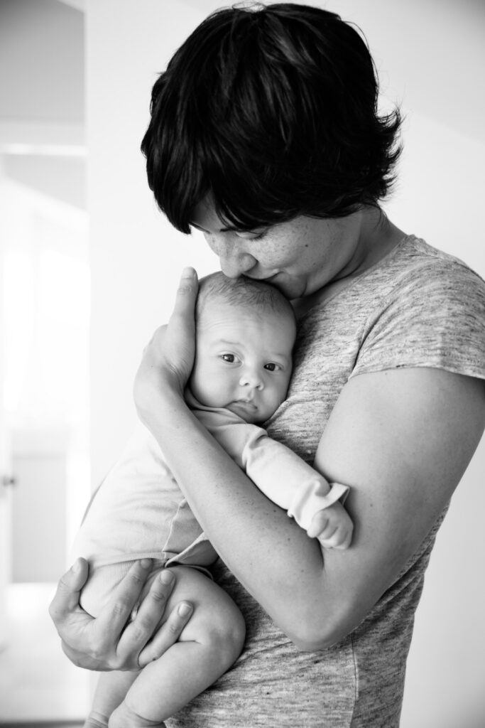 mom kissing baby boy's head family home session sf bay area