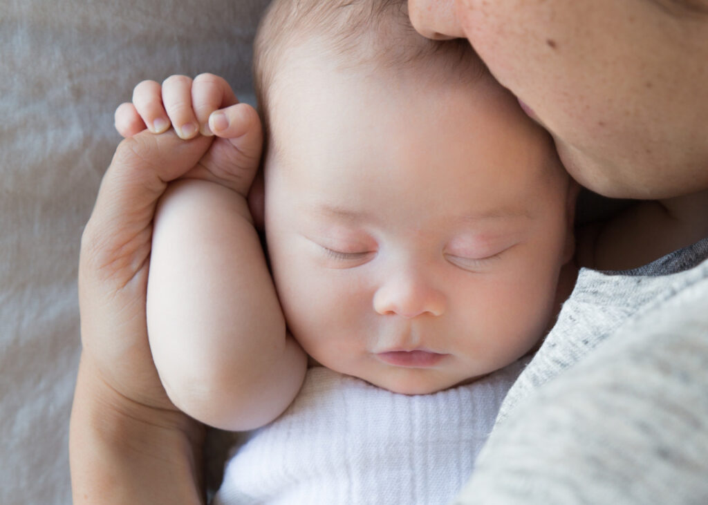 mom holding baby's hand sweet connection family home session sf bay area