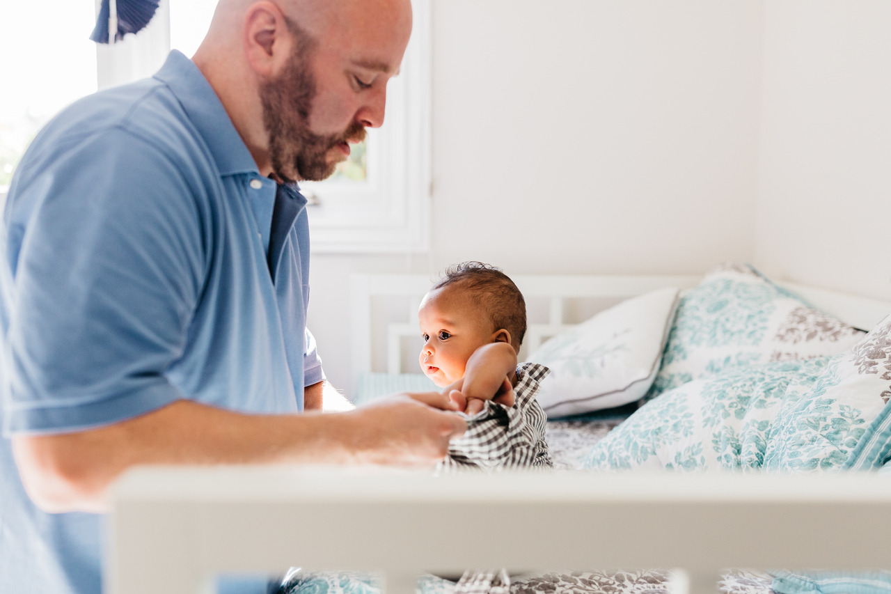 baby boy being changed by dad in nursery newborn home session sf bay area