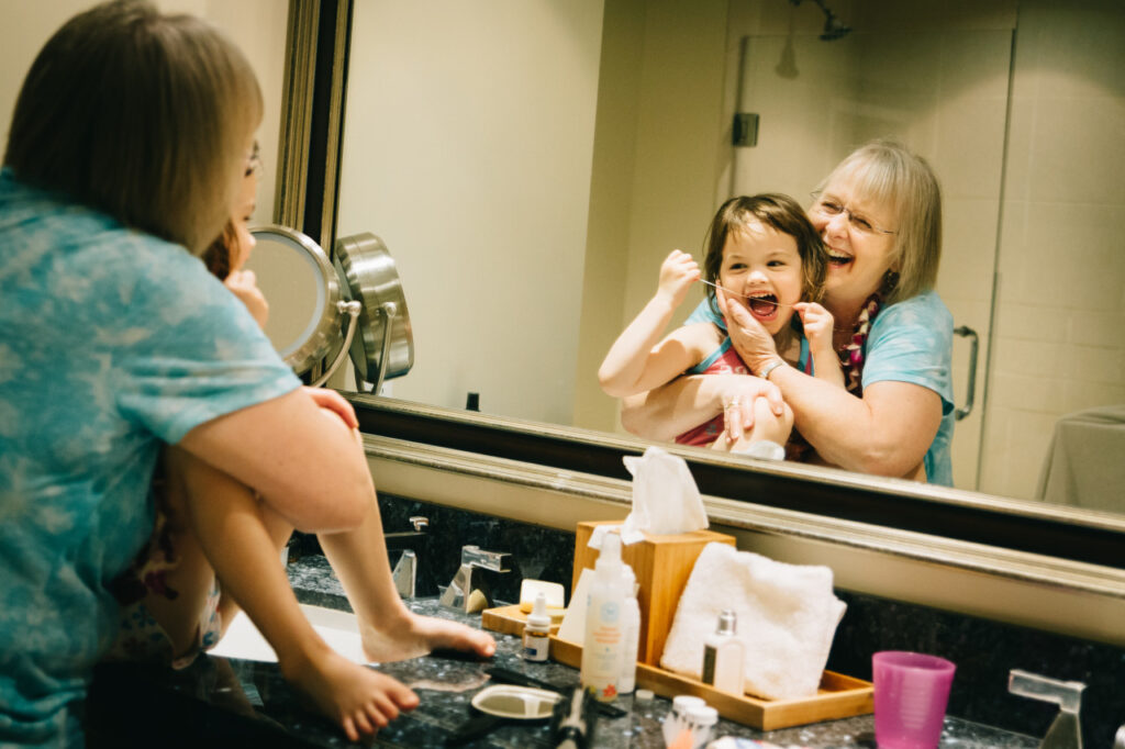 grandmother and granddaughter laughing bonding in bathroom family session sf bay area