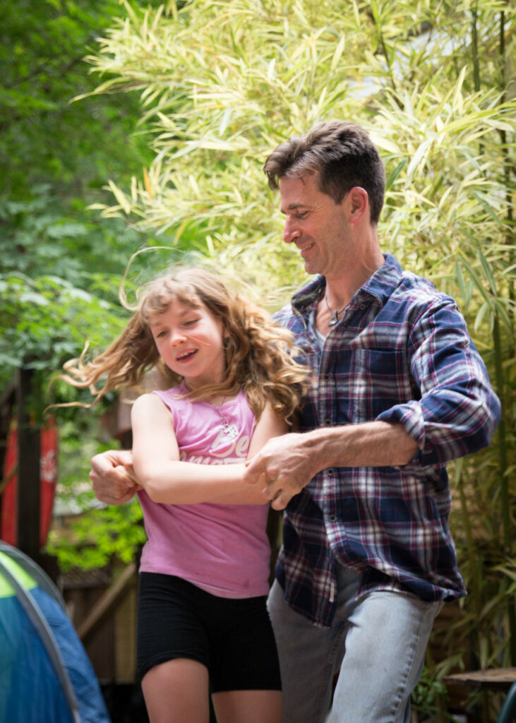 dad and teenage girl swing dancing having fun family session sf bay area russian creek cazadero