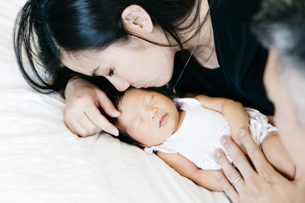mother kissing baby girl daughter newborn home session sf bay area