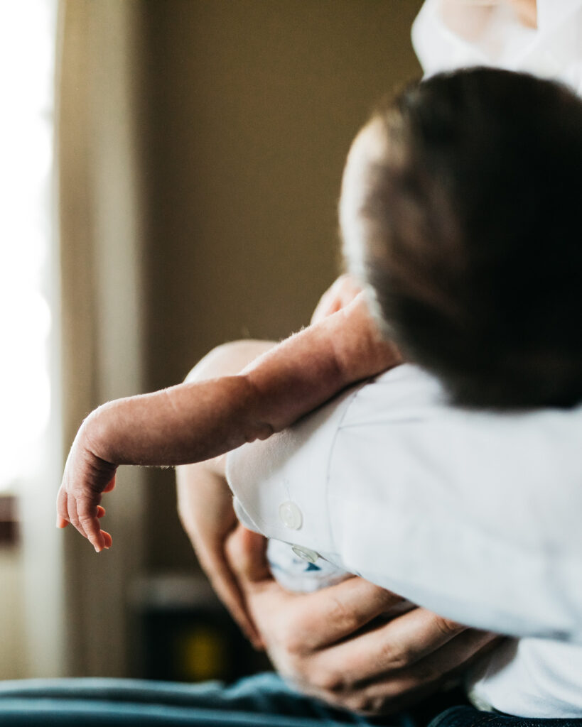arm of baby boy escaping dad's hold newborn session sf bay area