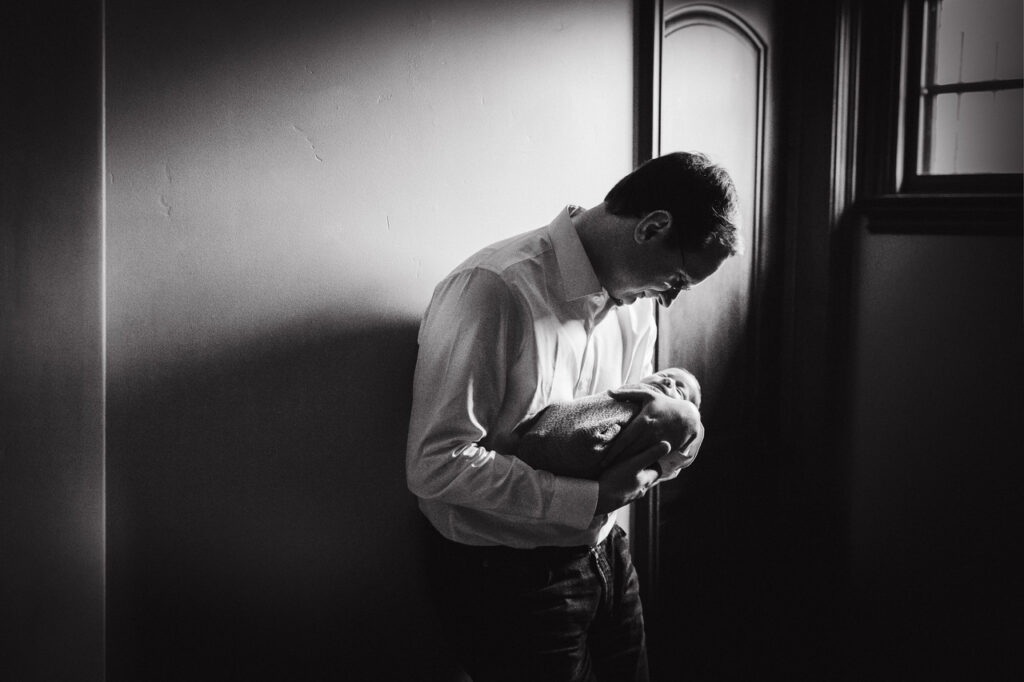 dad holding bonding with baby boy newborn session sf bay area