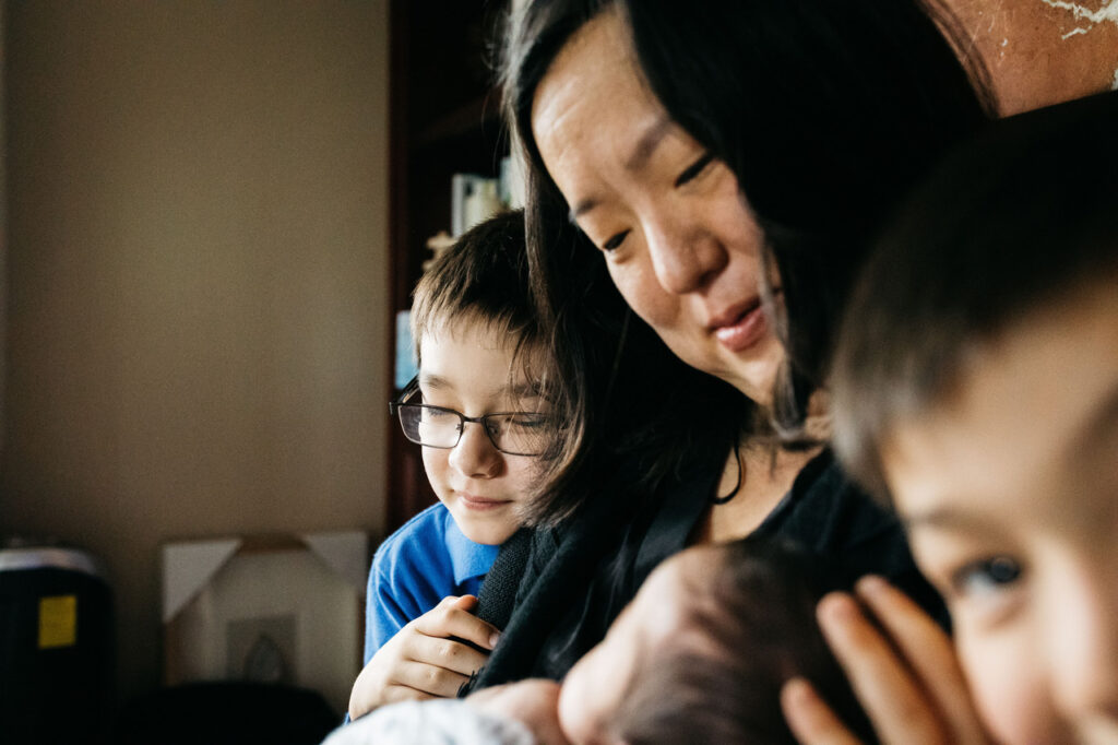 siblings and mother admiring baby brother newborn session sf bay area menlo park