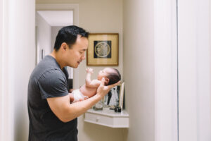 dad bonding holding baby son newborn home session sf bay area