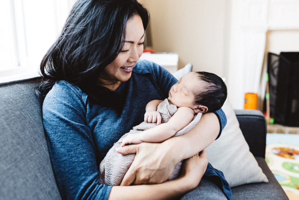 mom holding baby boy newborn home session sf bay area