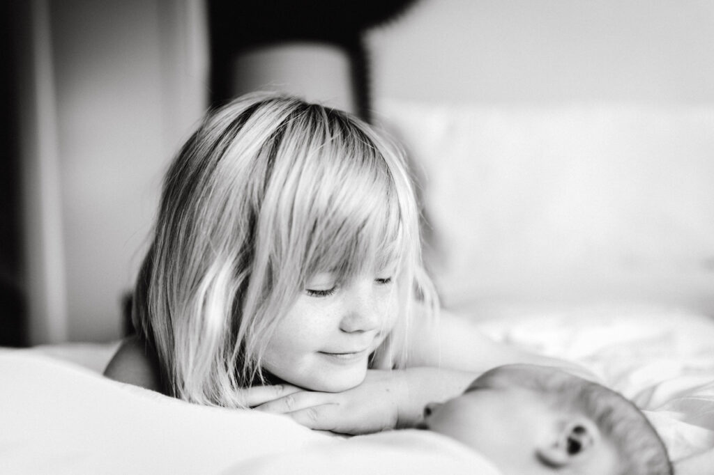 big sister looking adoringly at baby sister newborn home session bay area alameda