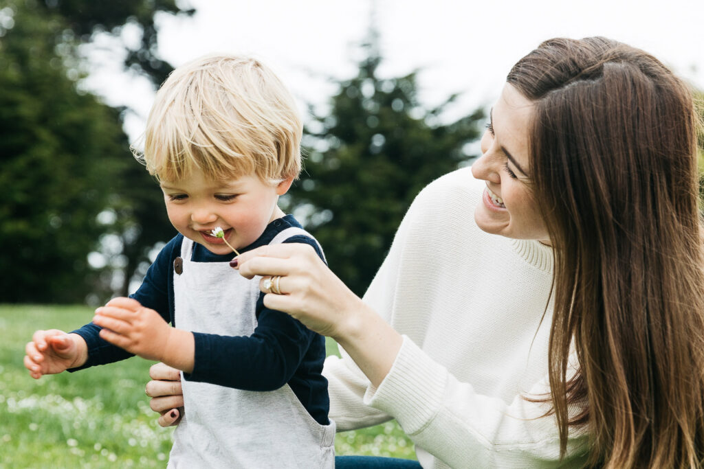 san-francisco-bay-area-family-photographer-carmen-dunham-photography-and-filmsIMG_5080 mom and son having fun laughing and playing with flowers in alamo square park san francisco