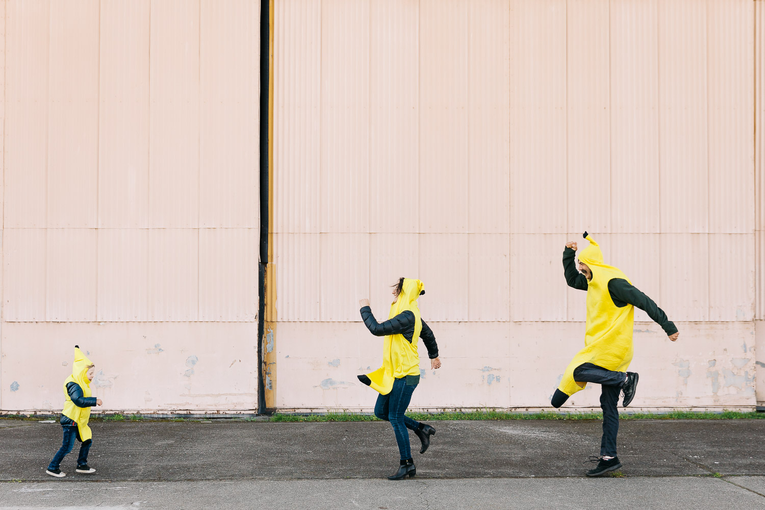 a family dressed up as bananas dancing at a family session in alameda