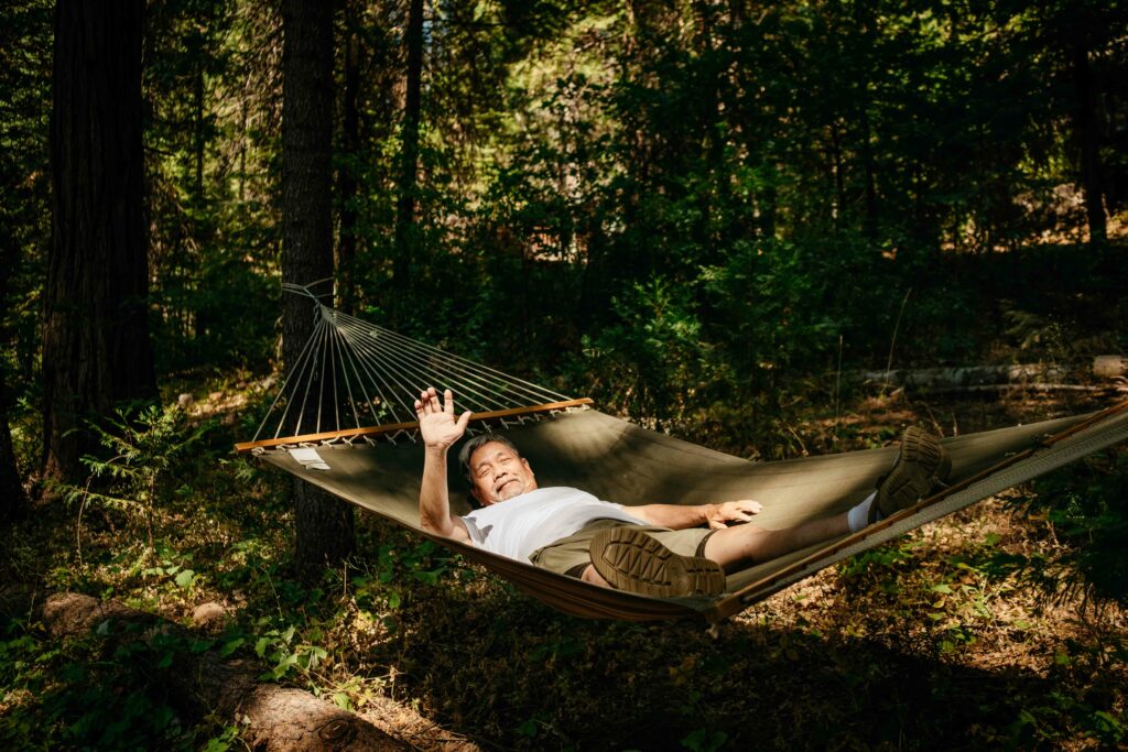 grandpa waving hello on a hammock in arnold california