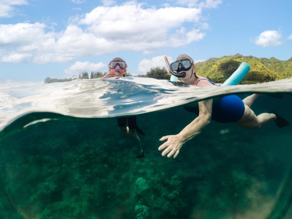 grandma and granddaughter snorkeling in kauai