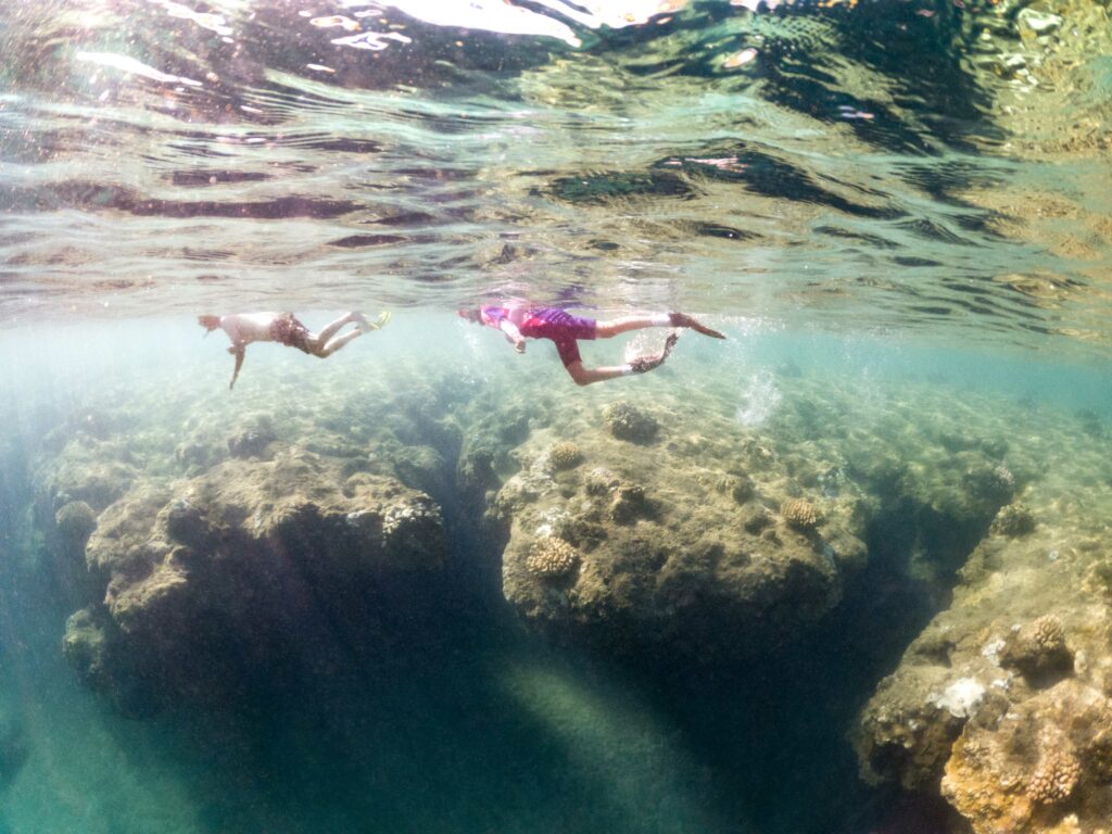 underwater family photo while snorkeling at tunnels beach in kauai