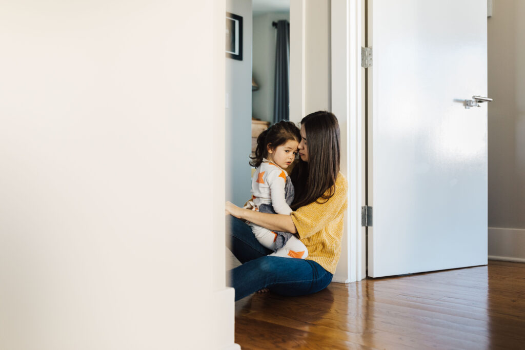 mother and daughter having a quiet moment together in the hallway
