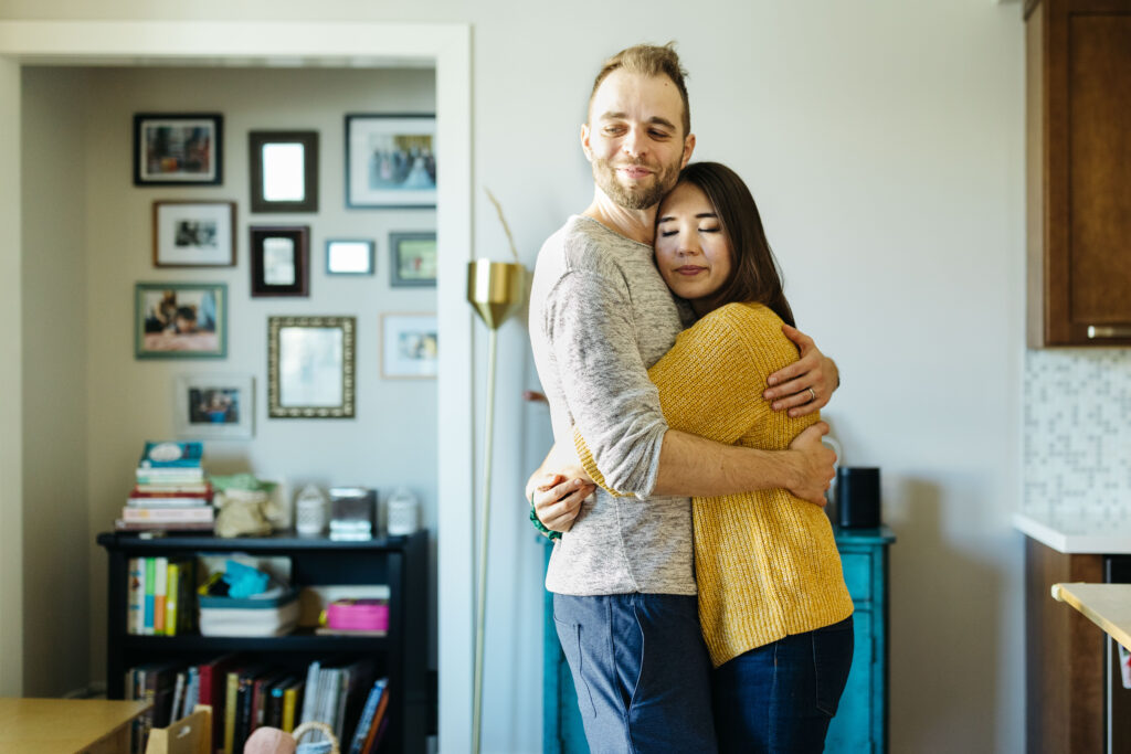 mom and dad hugging inside kitchen