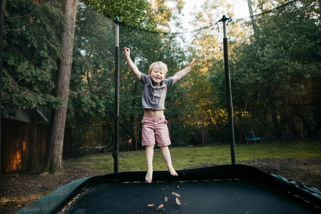 young boy in mid jump on trampoline