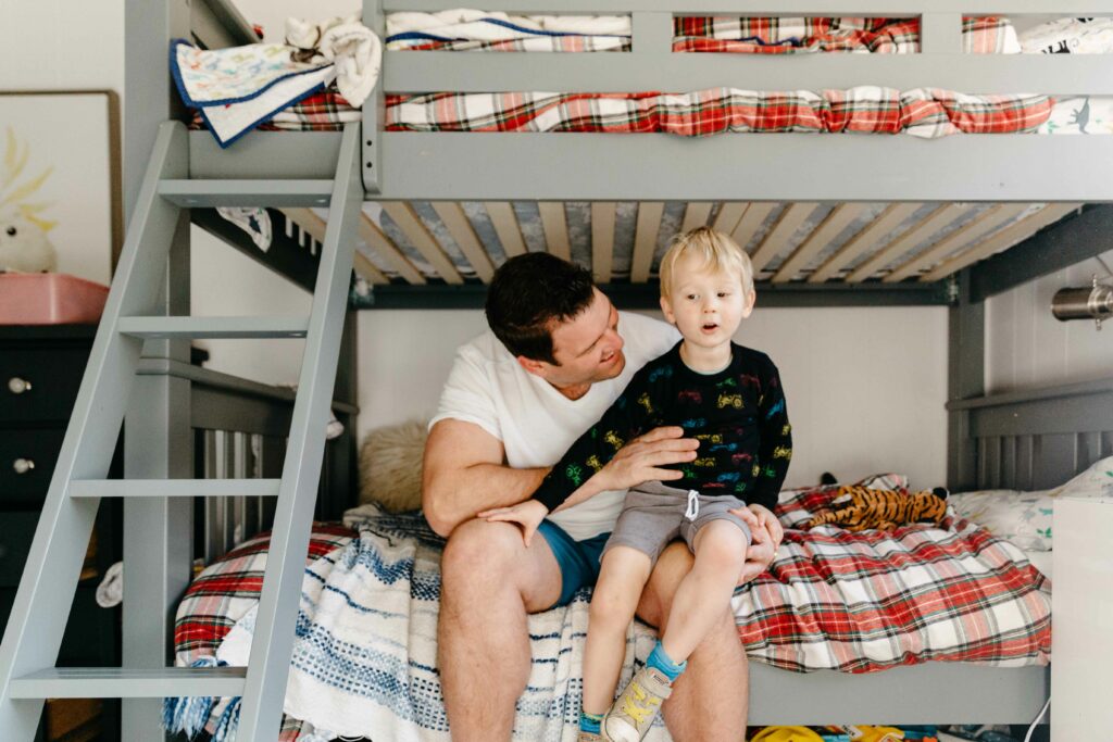 dad and son chatting on the bunk bed.