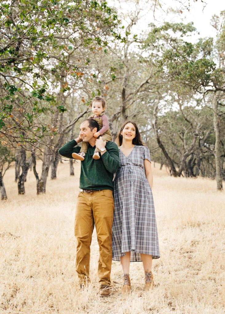 east-bay-family-photographer-IMG_0164-carmen-dunham-photography expecting family playfully posing for photos in grassy meadow with trees
