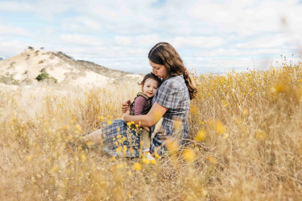 east-bay-family-photographer-IMG_0206-Edit-carmen-dunham-photography Expectant mother sitting in the tall grass with young daughter in her lap