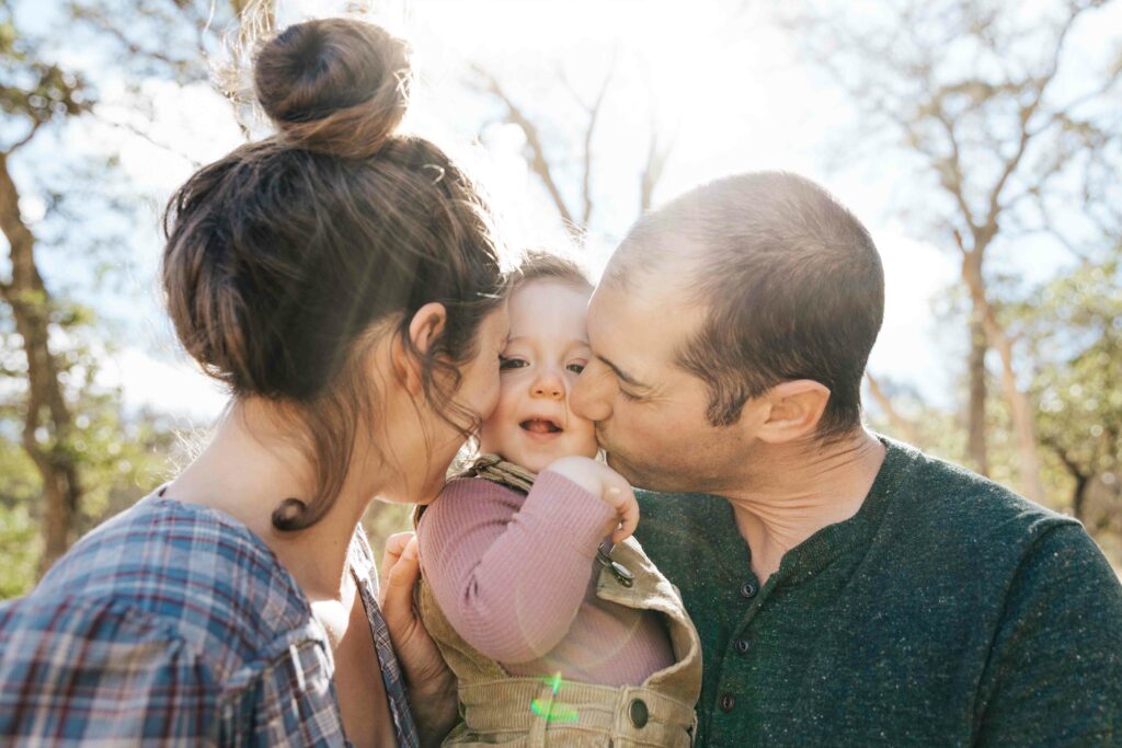 east-bay-family-photographer-IMG_0453-Edit-carmen-dunham-photography mother and father kissing young daughter