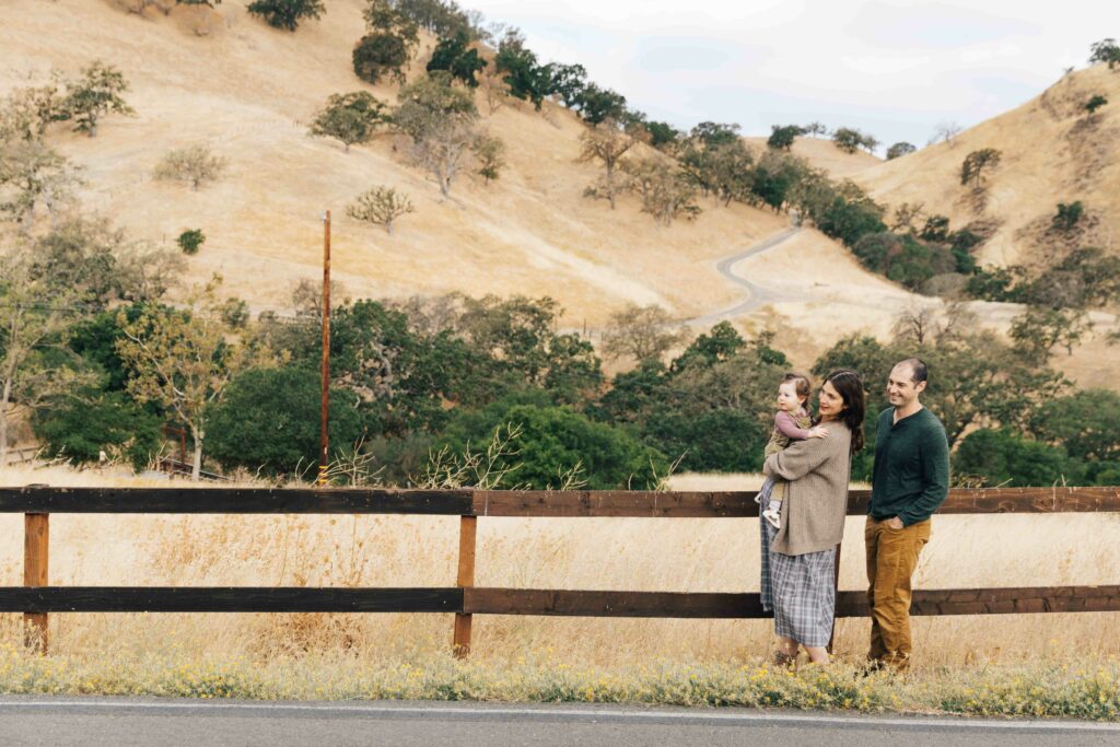 east-bay-family-photographer-IMG_9967-carmen-dunham-photography expecting family along wooden fence and hills at Old Borges Ranch