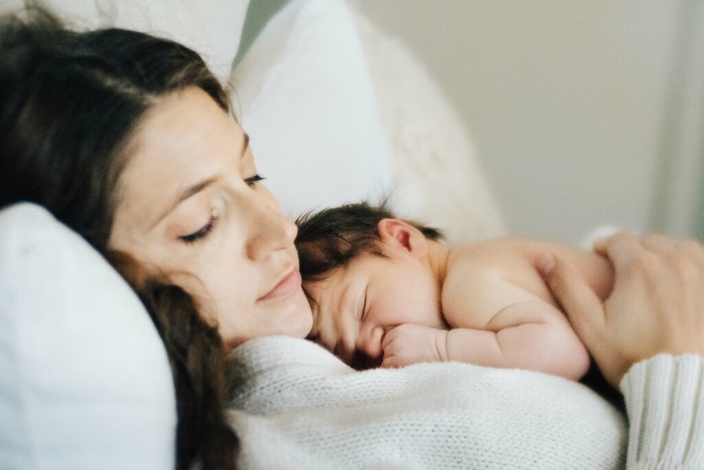 newborn boy sleeping on mother's chest