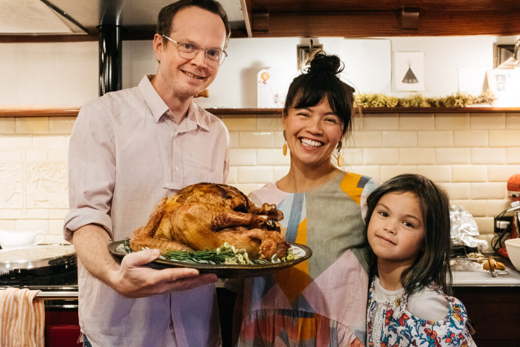 Family posing with the Thanksgiving turkey
