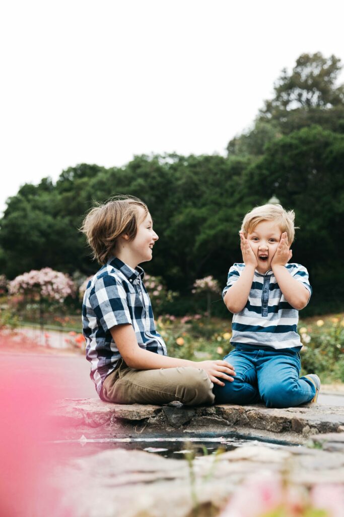 brothers playing at the fountain cascade in the Morcom Rose Garden
