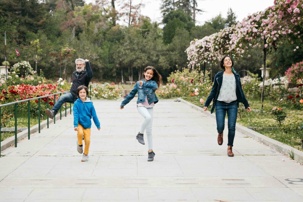 Family being goofy while walking at the Morcom Rose Garden.