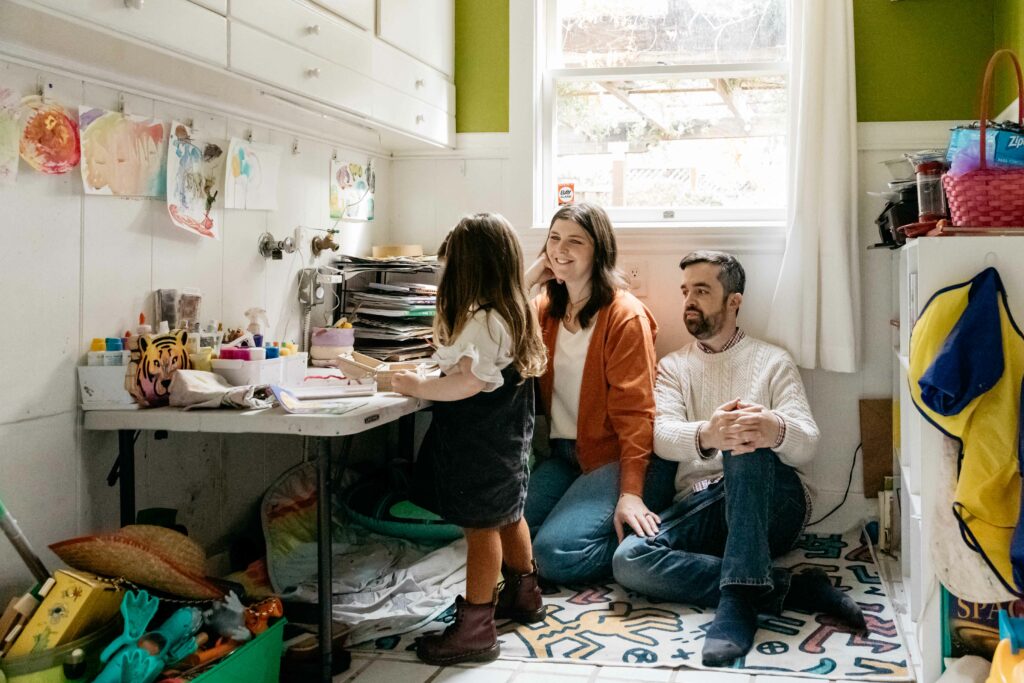 Mother and dad admiring daughter doing art in the house