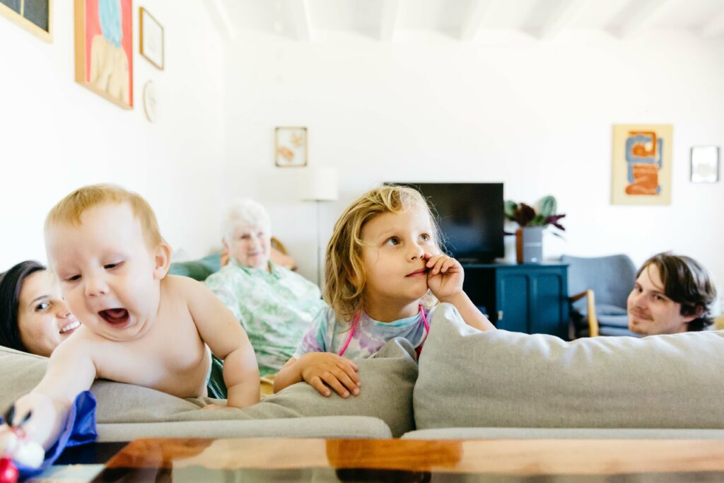 Candid group family photo taken on the sofa in the living room during a family photo and video session in the bay area