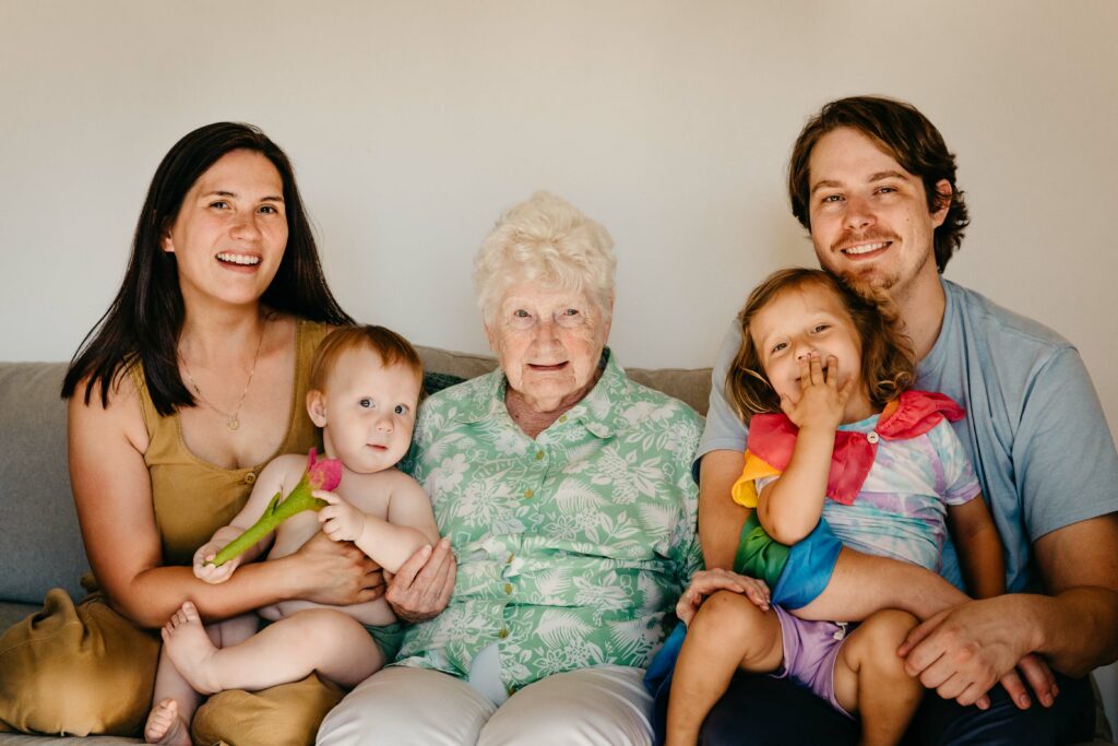 Family cuddling with grandma during a family photo and video session in sunnyvale, ca