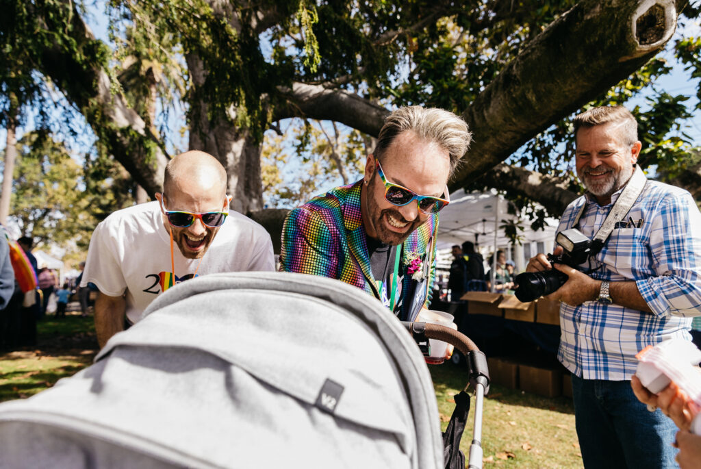 Dads laughing at daughter at Pride