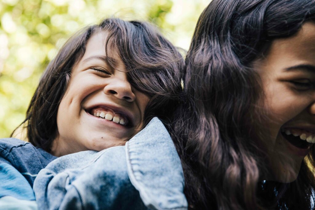 Siblings laughing on piggyback