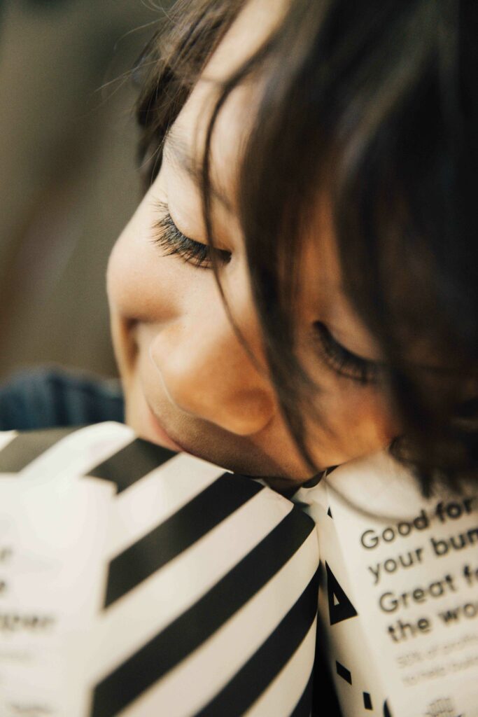 Son cuddling with rolls of toilet paper.