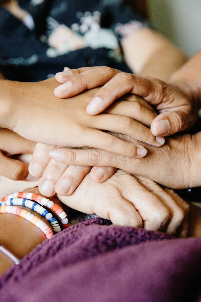 Family hands stacked during an in-home photo session.