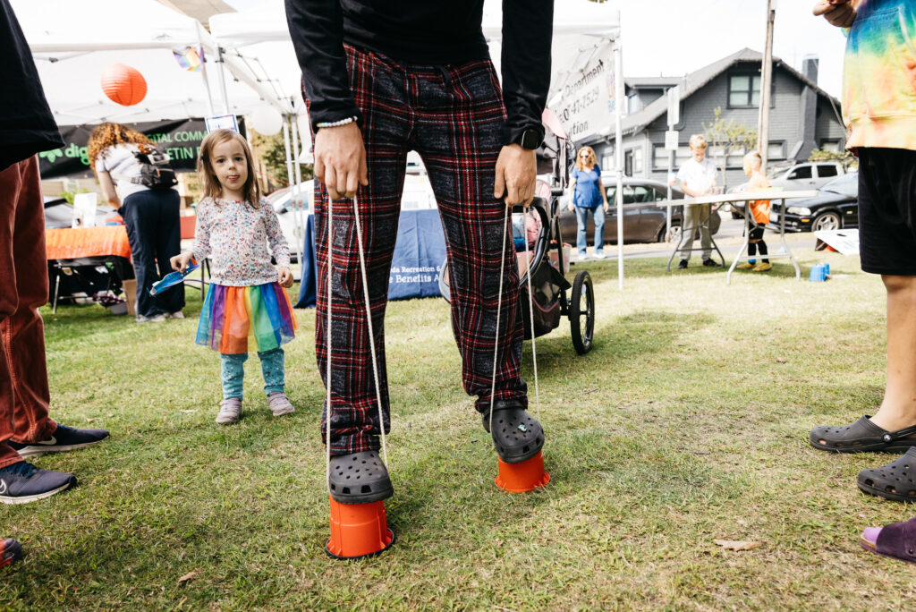 Man walking on cups at Alameda Pride