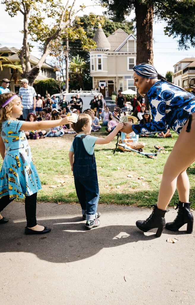 Drag diva being fabulous at Alameda Pride 2023 with young patrongs