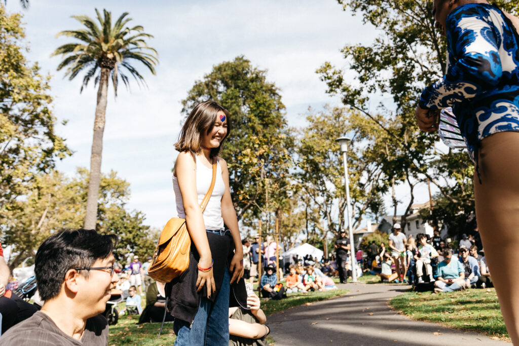 Teen girl having fun at drag performance at Alameda Pride