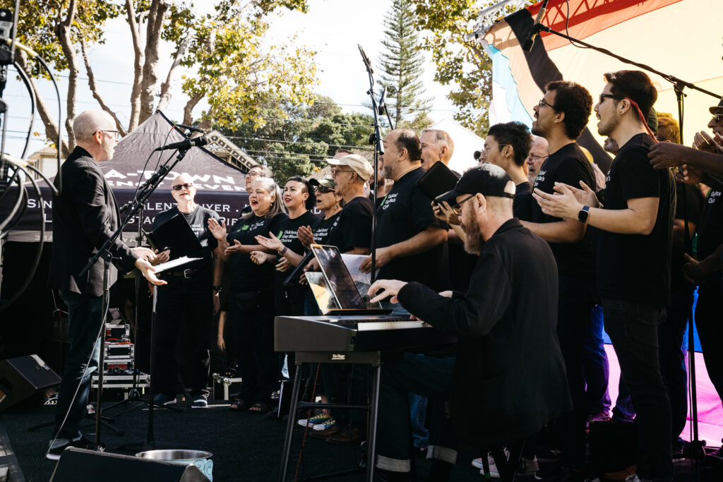 Oakland Gay Men's Chorus singing on main stage at Alameda Pride 2023