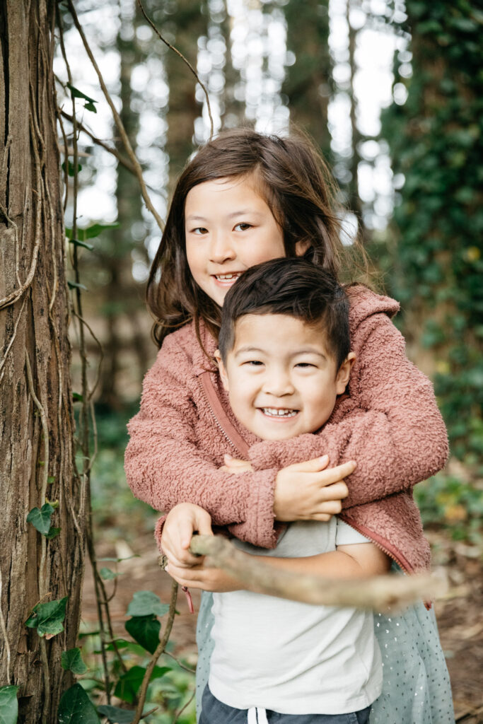 Siblings having fun during a family photo session in the Presidio.
