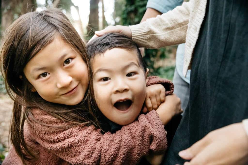 Brother and sister goofing around and being silly during a family photo session in San Francisco.