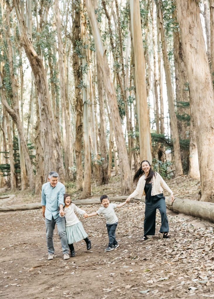 Family goofing around during a family photo session at Andy Goldsworthy Wood Line.