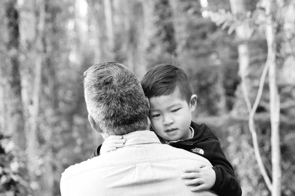 Father and young son sharing a heart to heart moment during a family photo session in the San Francisco.