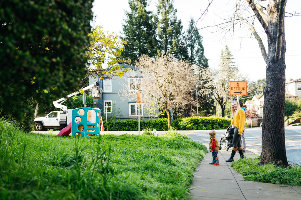 a family on a walk in an oakland neighborhood.